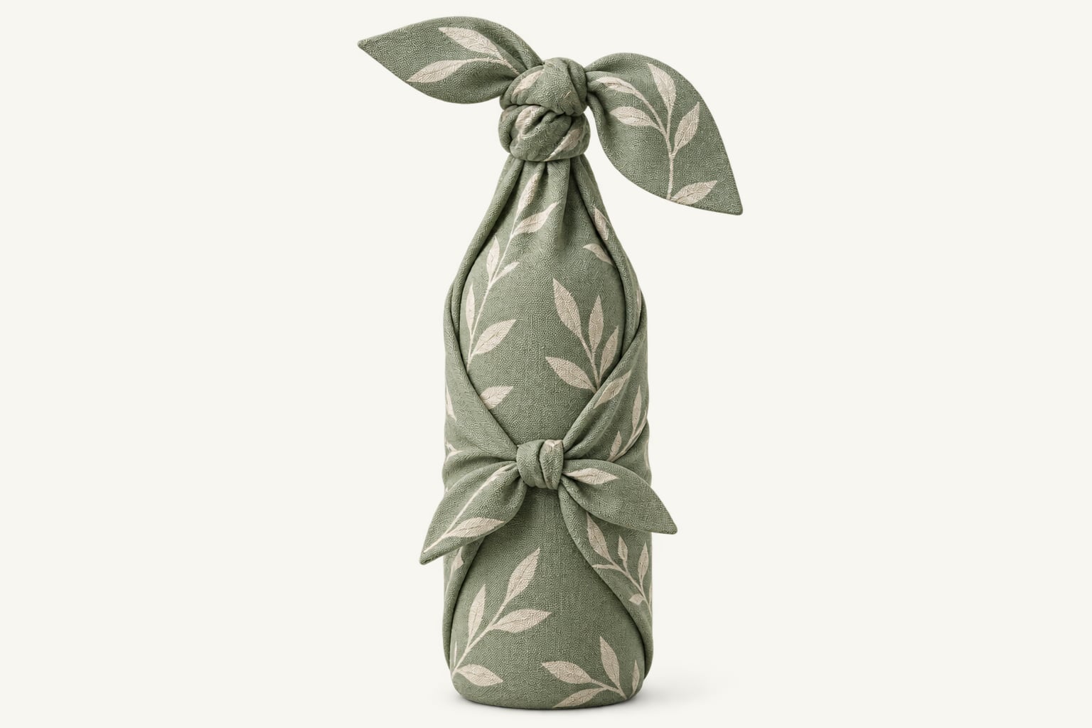 A bottle wrapped in green leaf-print cloth, knotted at the neck and the middle