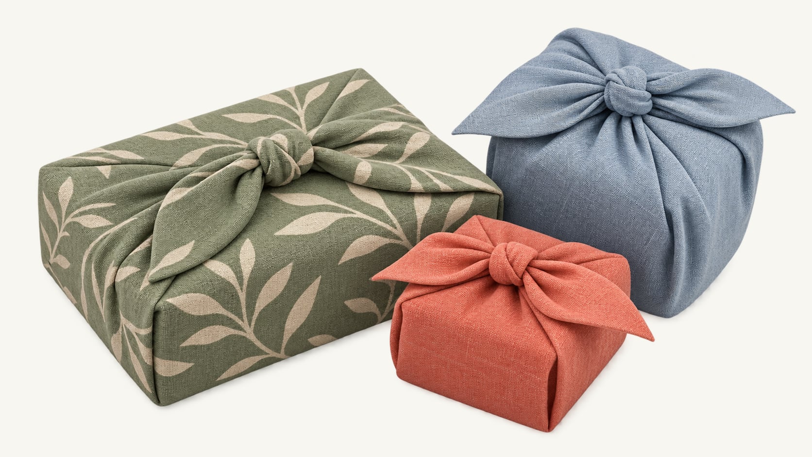 3 gifts wrapped in green, blue and coral cloth, each knotted on top