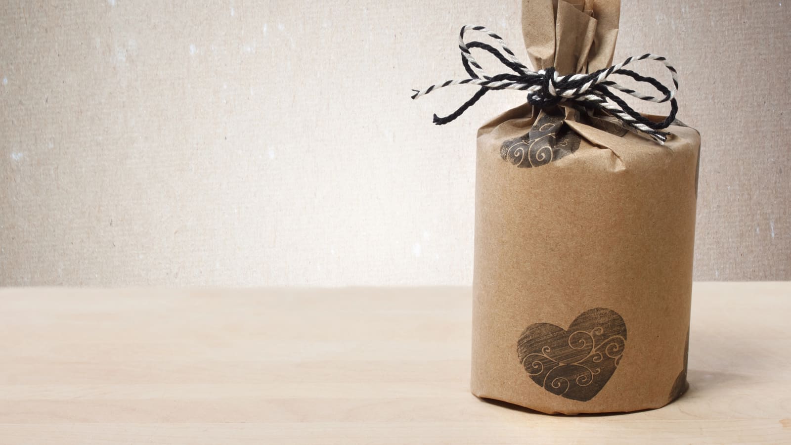 A cylinder wrapped in kraft paper and gathered at the top with twine