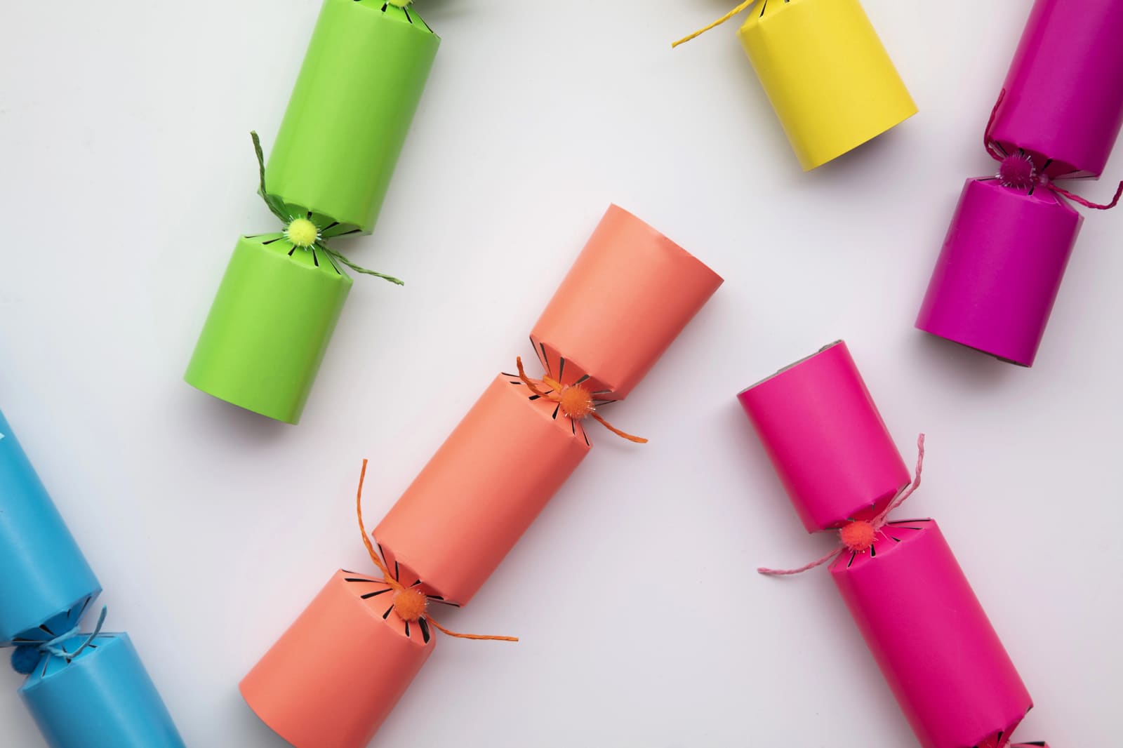 Bright paper-wrapped tubes twisted at both ends like crackers