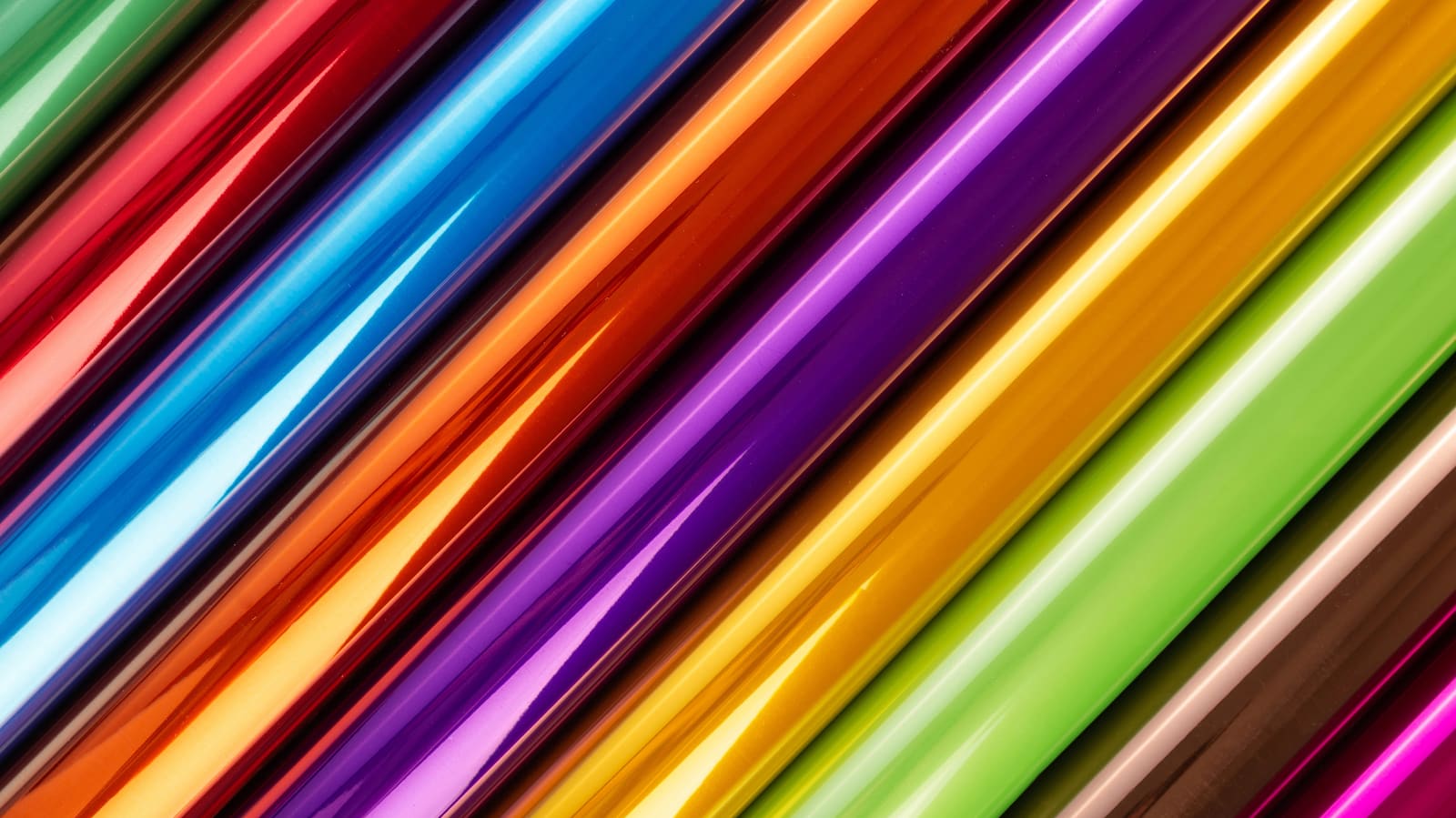 Rolls of shiny foil wrapping paper in rainbow colours
