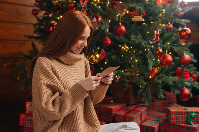 A woman reading a homemade Christmas card