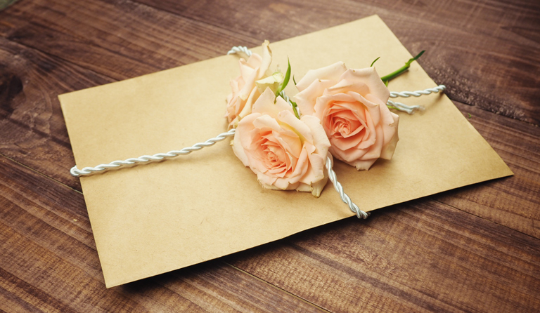 A love letter with flowers attached to it