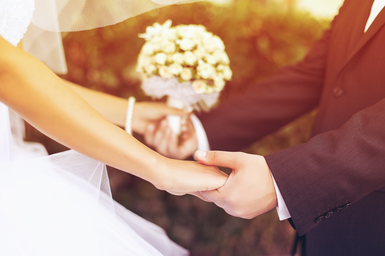 Wedding couple holding hands